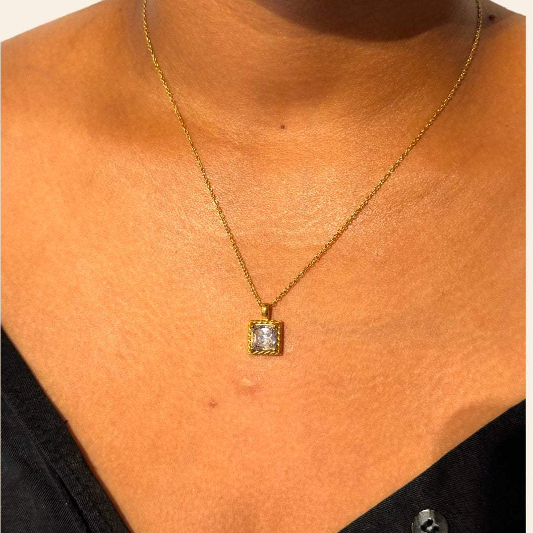 Allure Necklace with clear zircon pendant worn on model, twisted frame