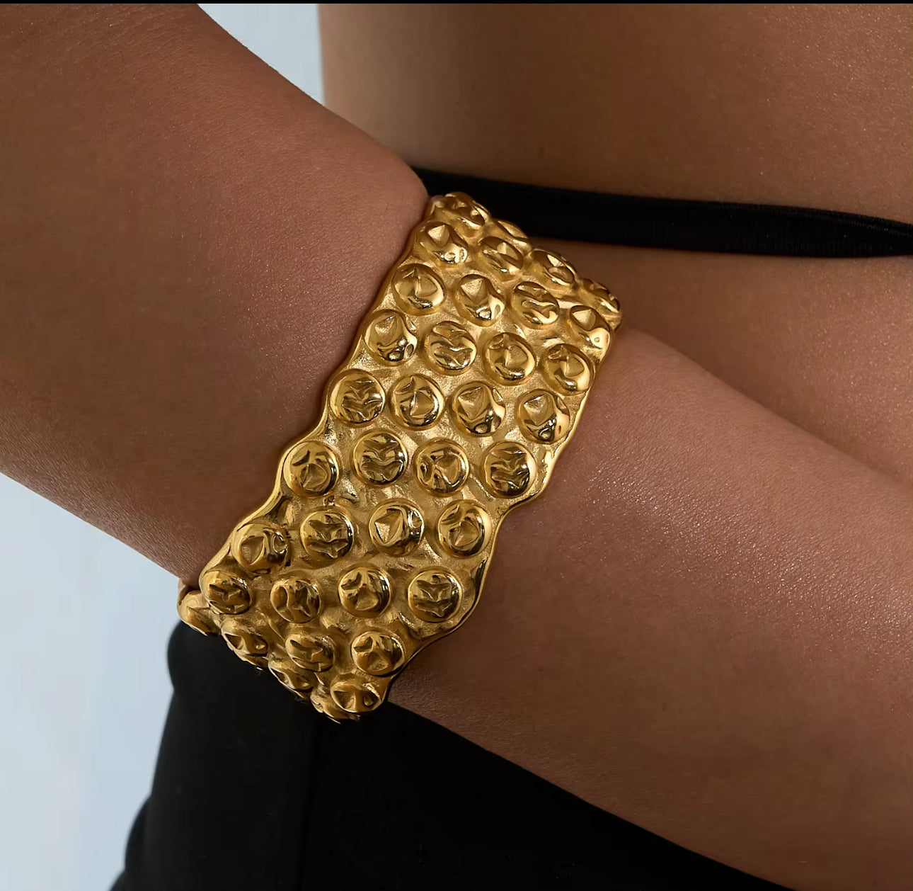 Model wearing the Lava Bangle, textured 18k Gold-Plated stainless steel design, waterproof tarnish-free hypoallergenic statement jewelry gift