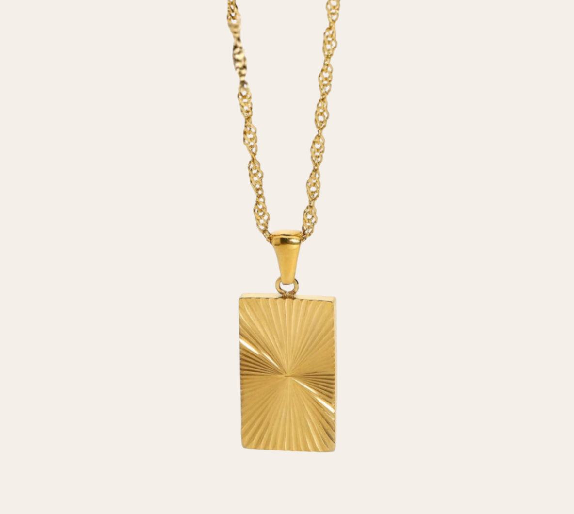 Solar Ray Necklace with sunburst rectangular pendant on plain background