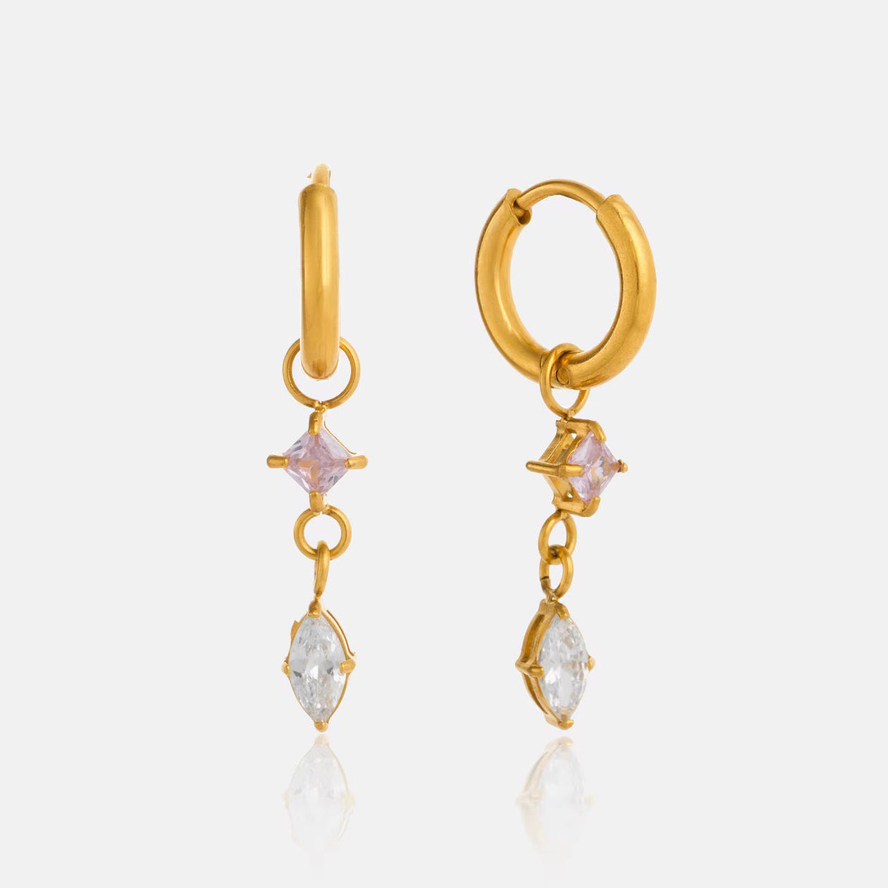 Gold hoop earrings with gemstone drops on a white background