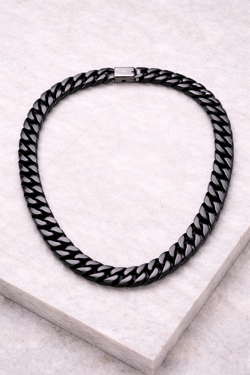 Black and white braided necklace on a light gray surface