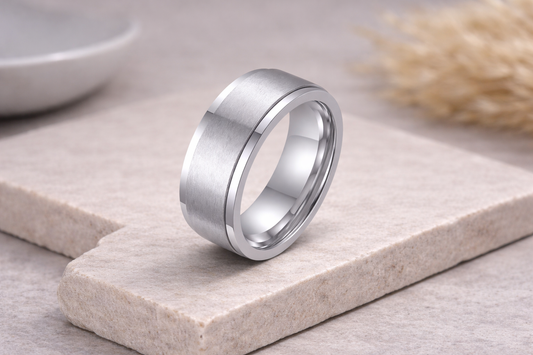Silver ring on a stone surface with a blurred background