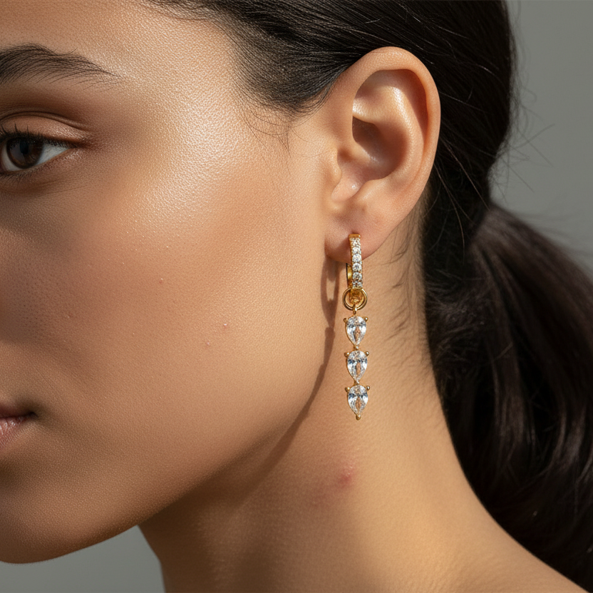 Close-up of a woman wearing a gold and diamond earring.