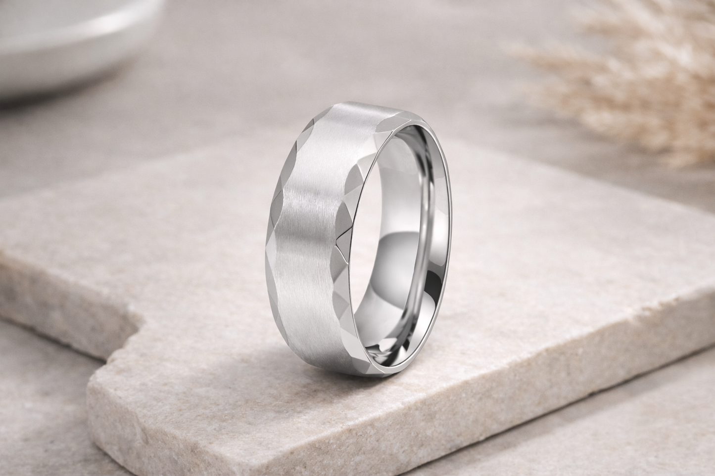 Silver ring on a stone surface with a blurred background