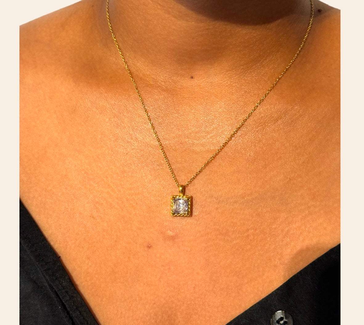 Allure Necklace with clear zircon pendant worn on model, twisted frame