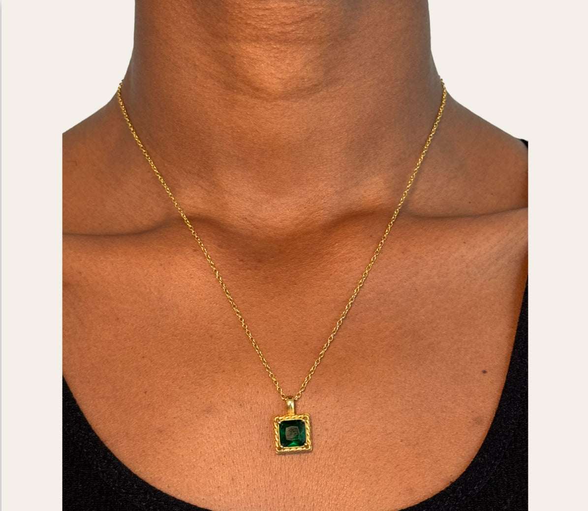 Allure Necklace with emerald-green zircon pendant worn on model, twisted frame