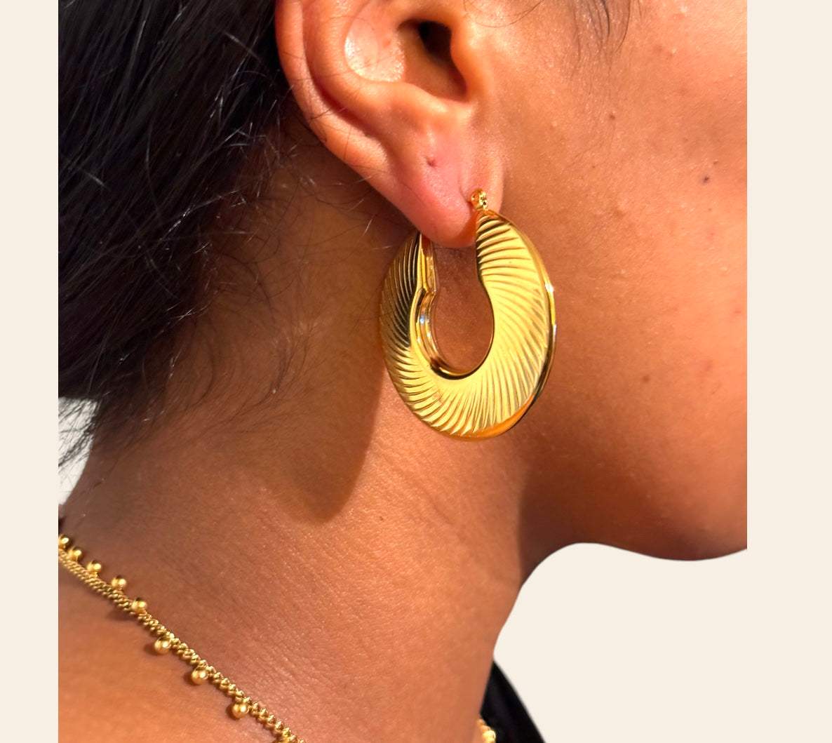 Ari Earrings on model  ribbed open-crescent hoops, 40 mm