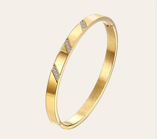 Astra Bangle in 18k gold-plated stainless steel (316L) with subtle diagonal cut design, waterproof hypoallergenic tarnish-free bracelet