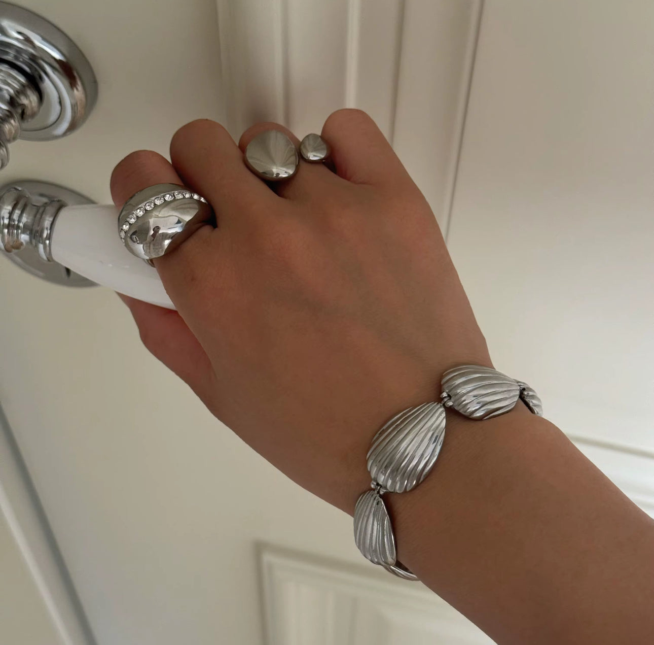 Model wearing the Aurora Shell Bracelet in 18k gold-plated stainless steel, waterproof statement jewelry