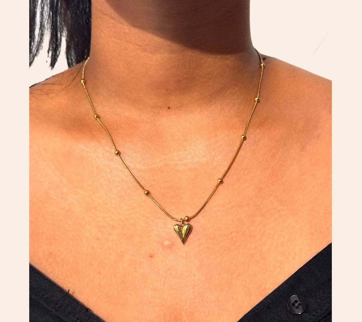 Blossom Heart Necklace worn at the collarbone, beaded chain and heart pendant