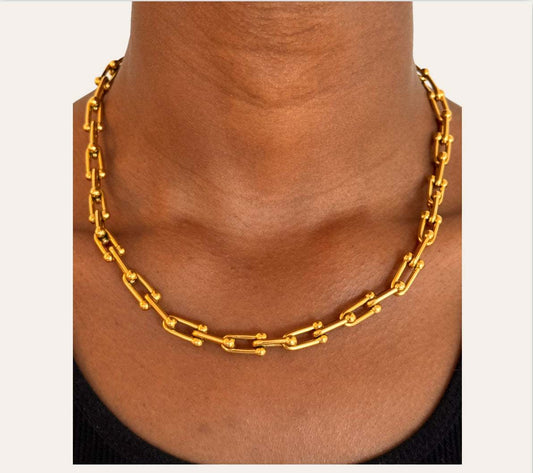 Capri U-Link Chain Necklace worn at the collarbone, polished U-links with bead details