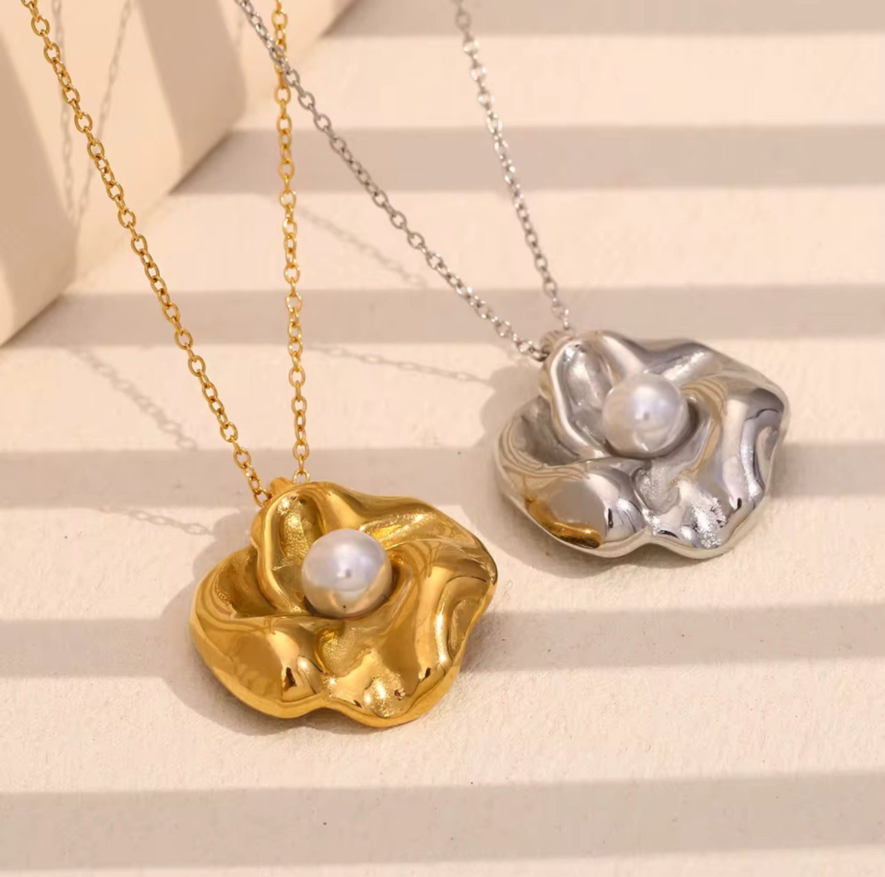 Gold and silver floral pearl necklaces side by side showing both color options and elegant design.