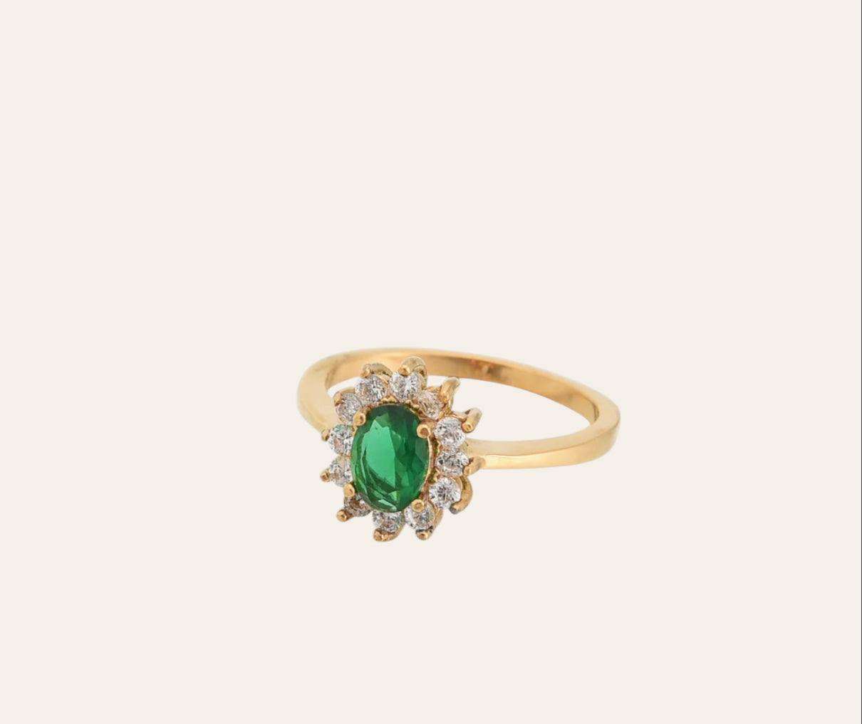 Flower Ring, gold-plated band with green oval zircon and clear zircon halo on plain background