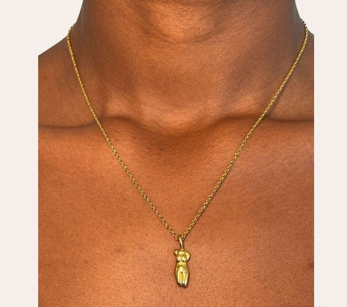 Goddess Torso Necklace in 18k gold-plated 316L worn at the collarbone, sculpted pendant