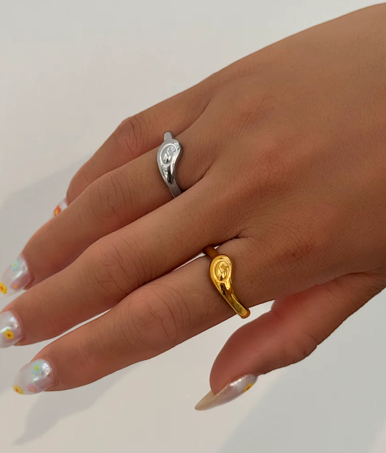 Model wearing the Infinity Ring on different fingers for a layered look