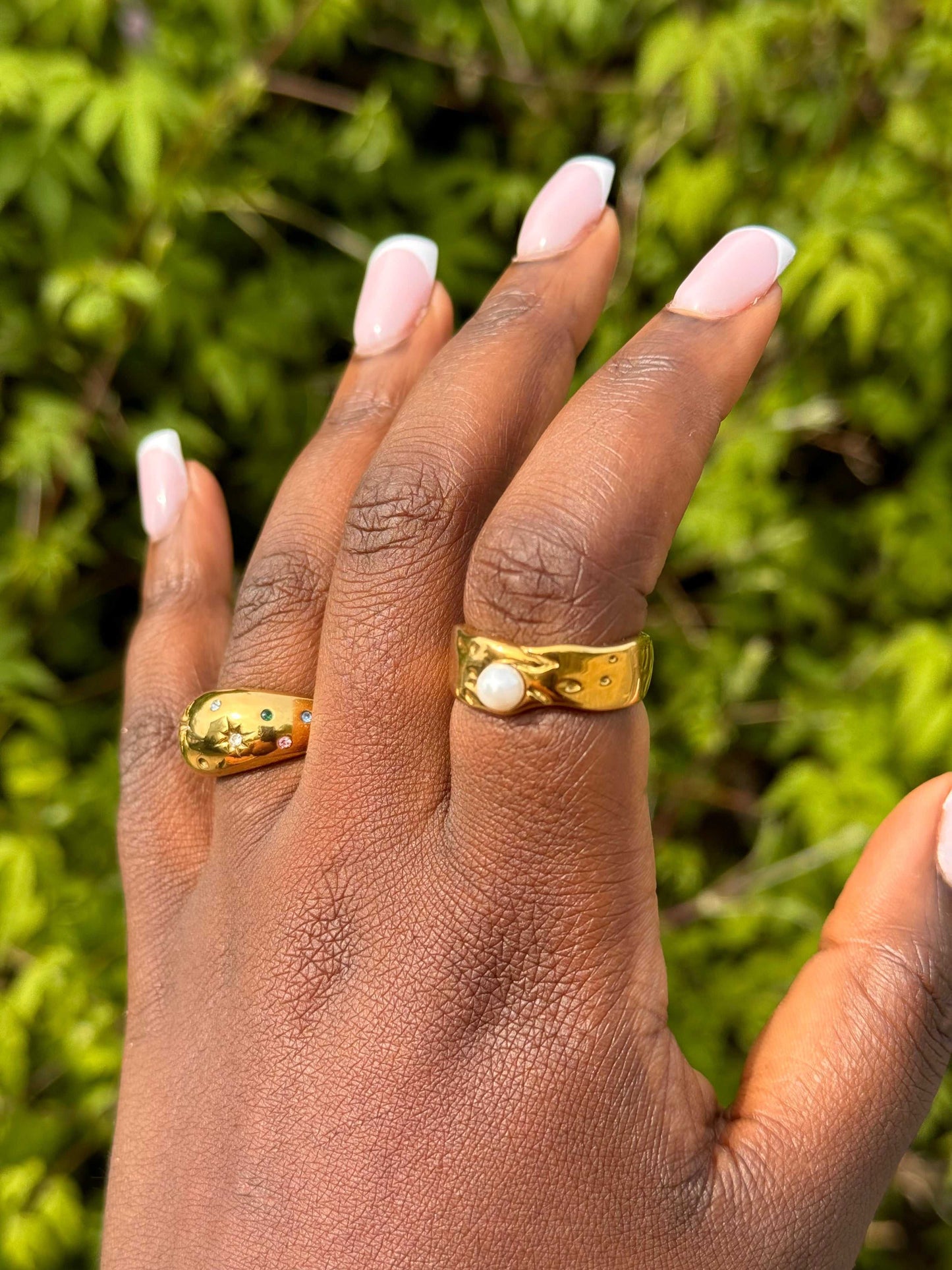 Detail of the Jolly Ring’s bezel-set imitation pearl on model’s hand