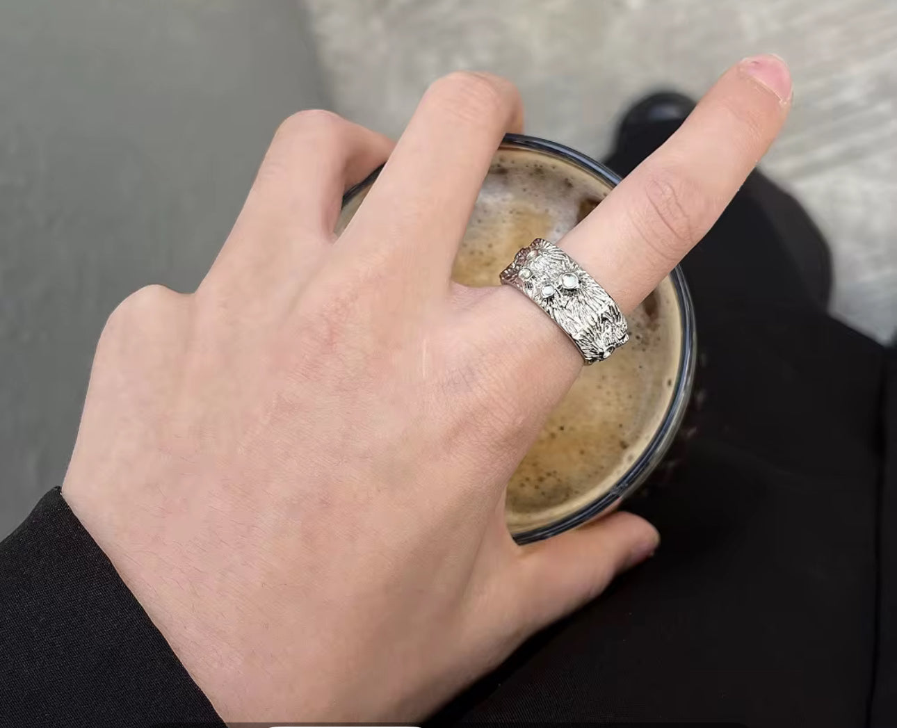 Model wearing the Lava Ring textured stainless steel band with cratered, molten look