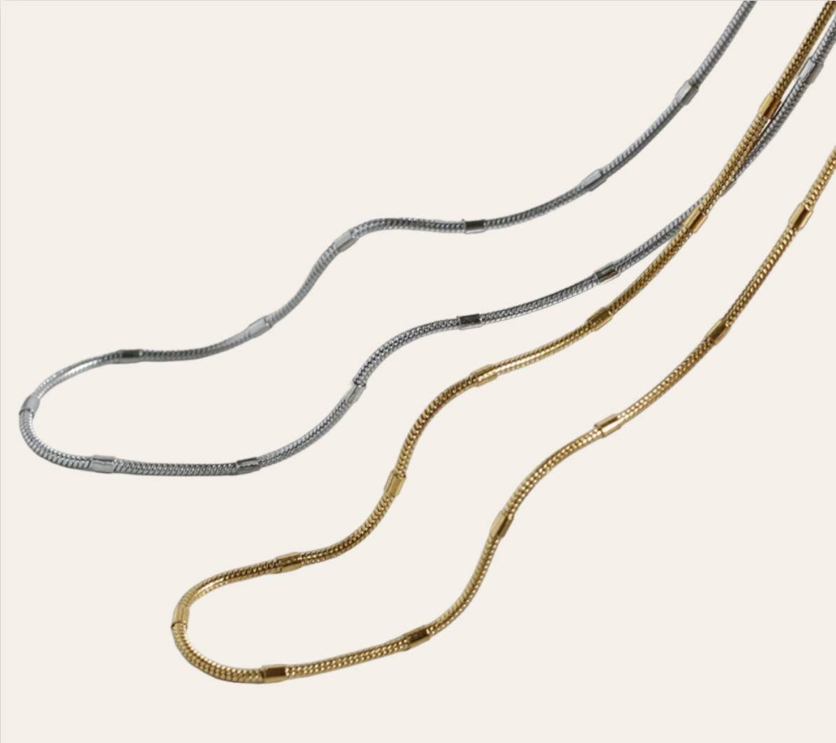 Mira Station Necklace in 18k gold-plated 316L on plain background, polished bar stations