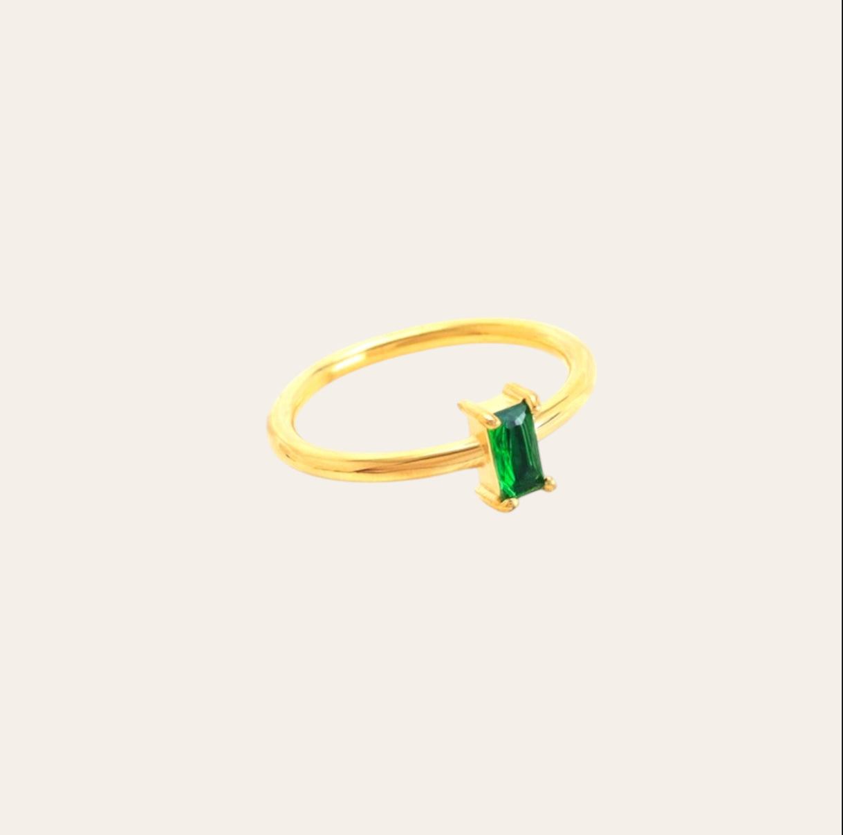Moss Ring, slim gold-plated band with baguette-cut green zircon on plain background