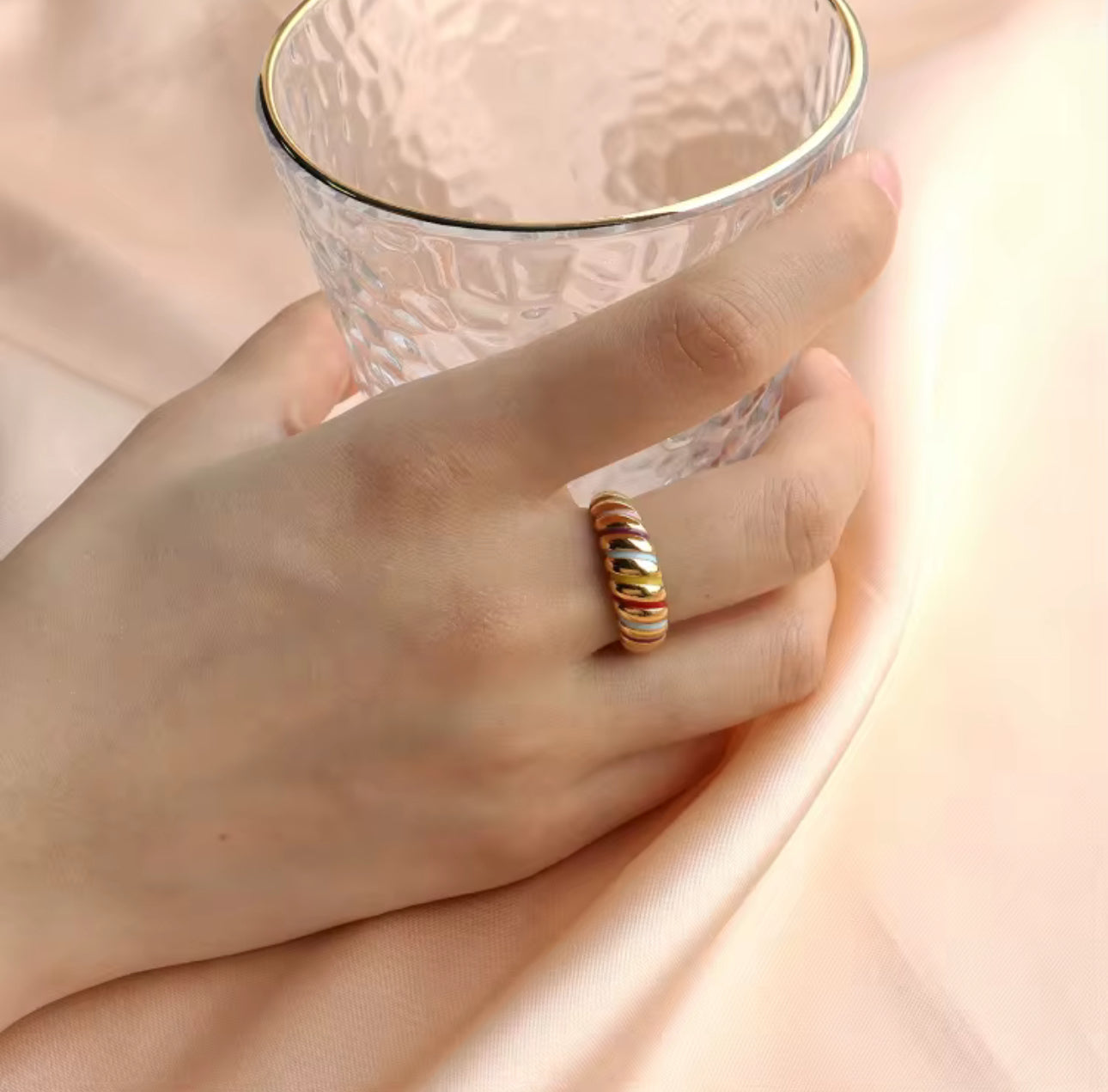 Model wearing Rainbow Ring close-up showing multicolor enamel stripes