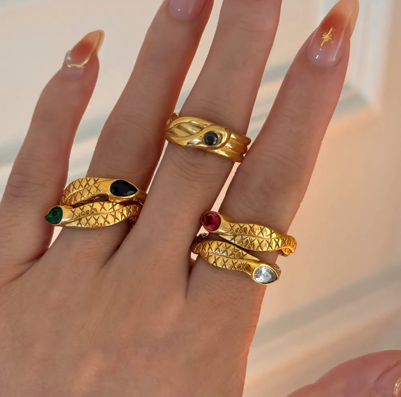 Model close-up wearing the Snake Ring; scale-pattern band and stone detail visible.