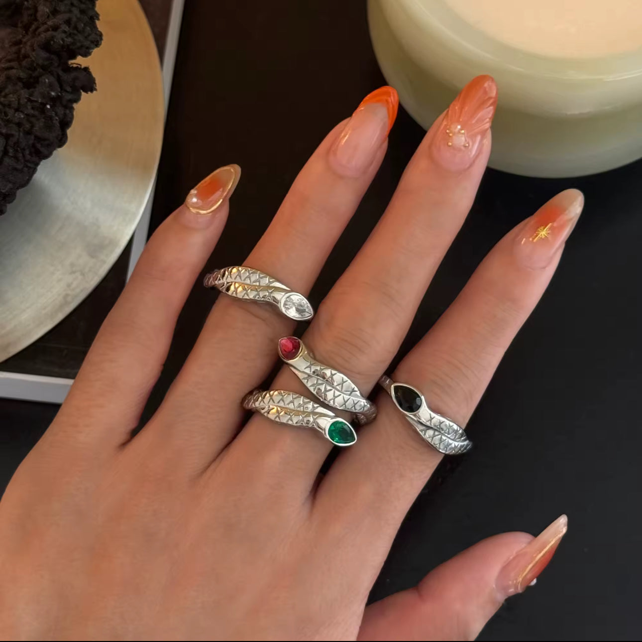Model wearing the Snake Ring stacked with other bands for a layered look.