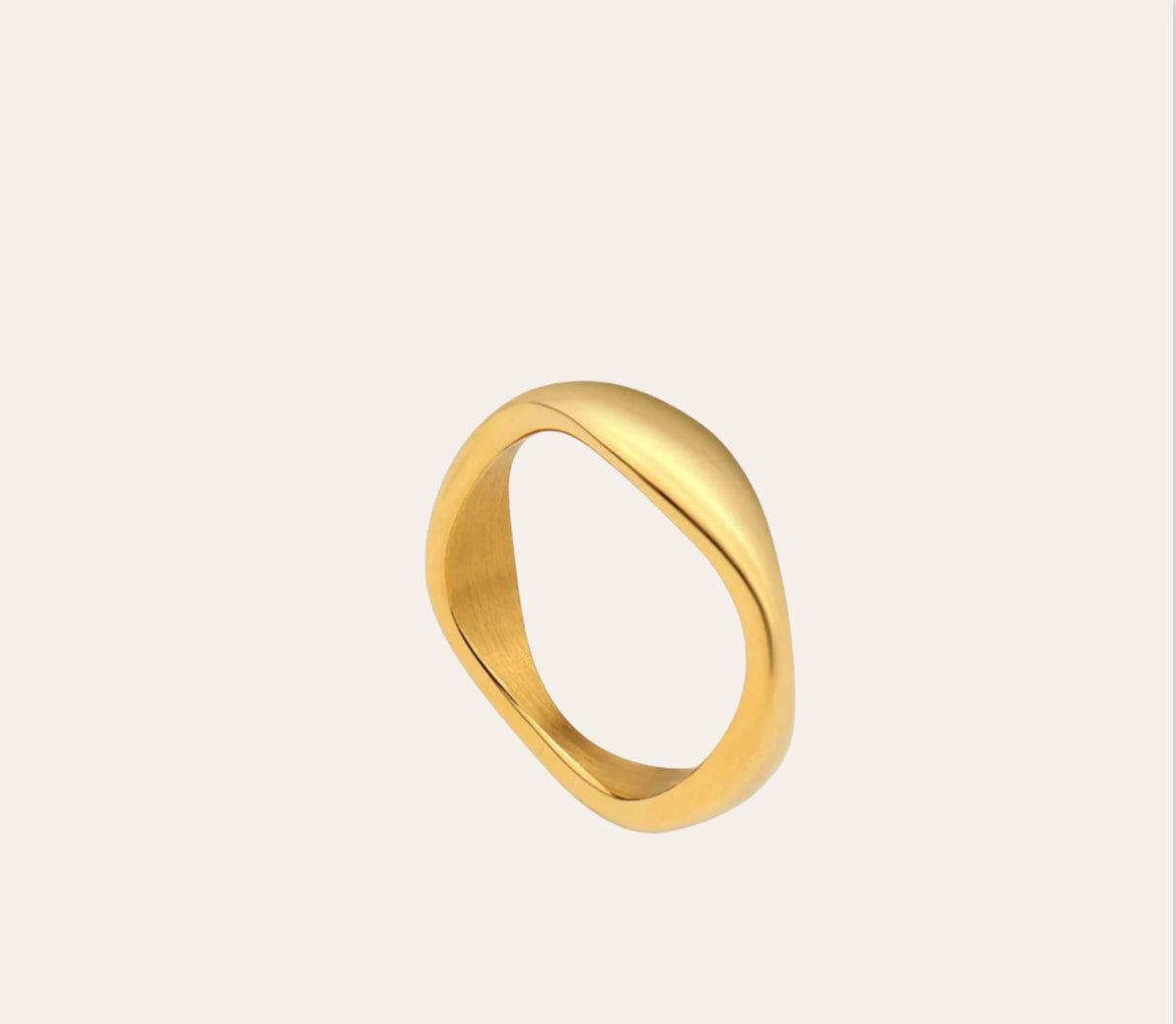 Sway Ring, minimal wave band in 18k gold-plated 316L stainless steel on plain background