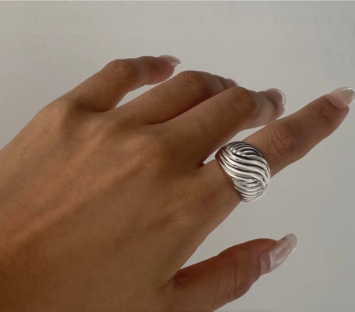 Model wearing the Swirl Ring textured stainless steel dome band with swirl grooves