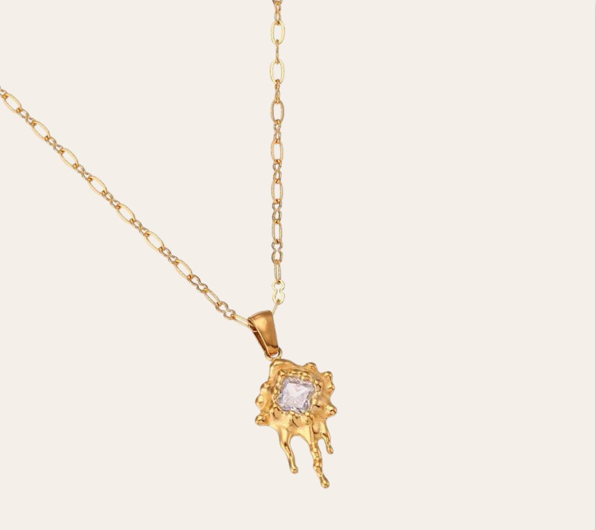 Zuri Necklace on plain background—molten sun pendant with square-cut zircon